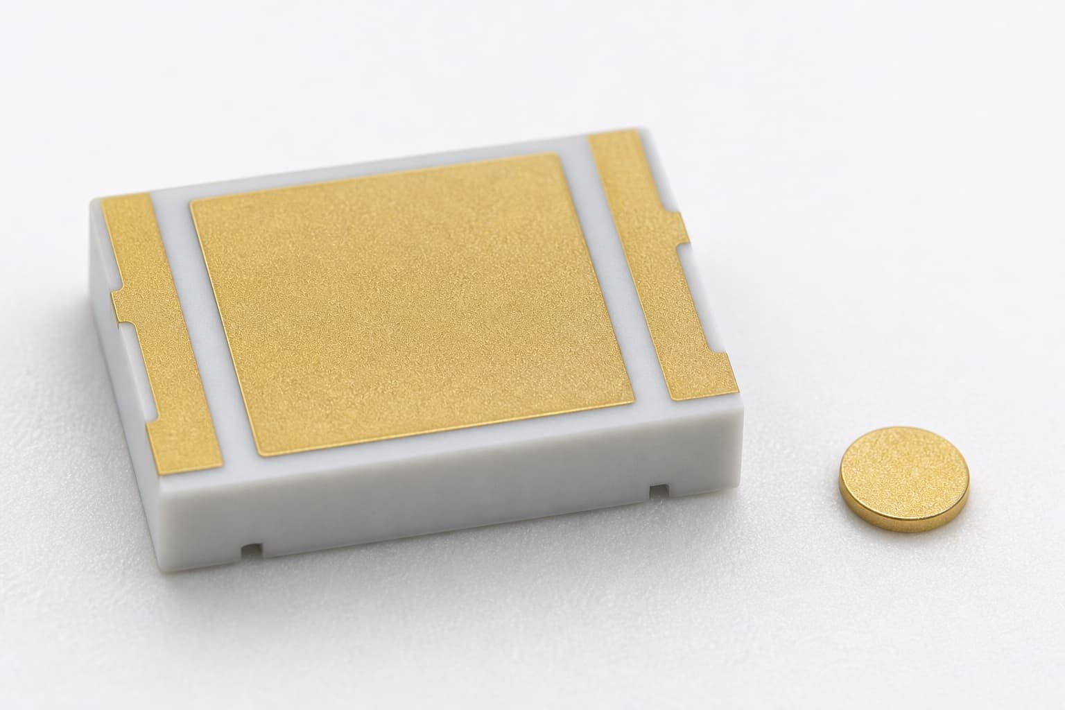 ALN laser submount with pre-deposited AuSn bonding pad beside a small AuSn solder preform for die attach comparison.